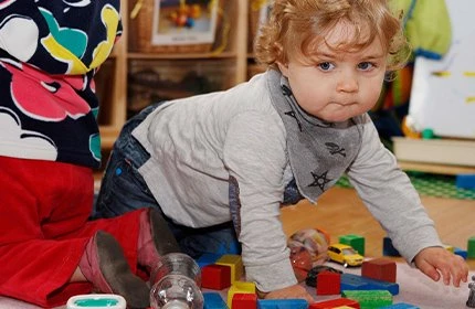 Child crawling in nursery setting