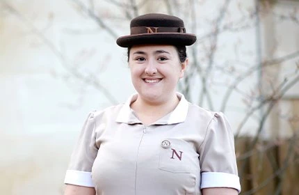 female headshot in Norland nanny uniform