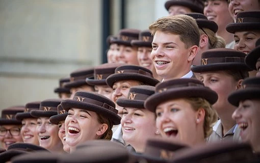 group of Norland nannies laughing standing on steps