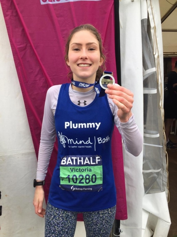 image of girl with a marathon medal