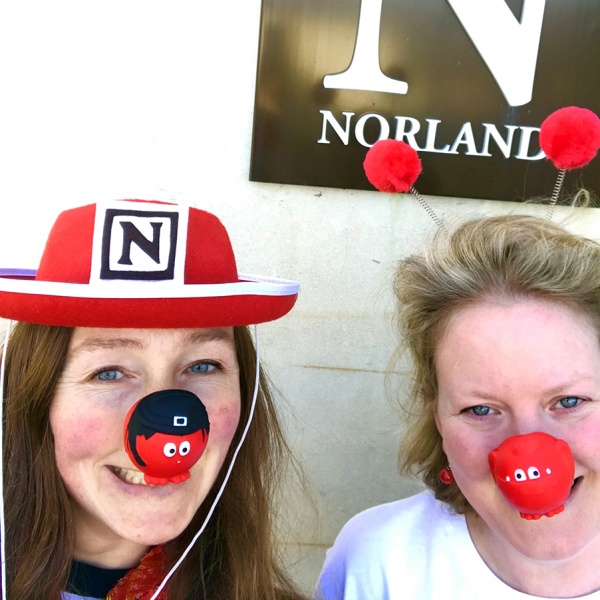 image of two women with red noses on