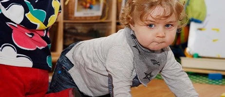 child crawling in nursery setting