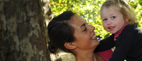 early years teacher holding child