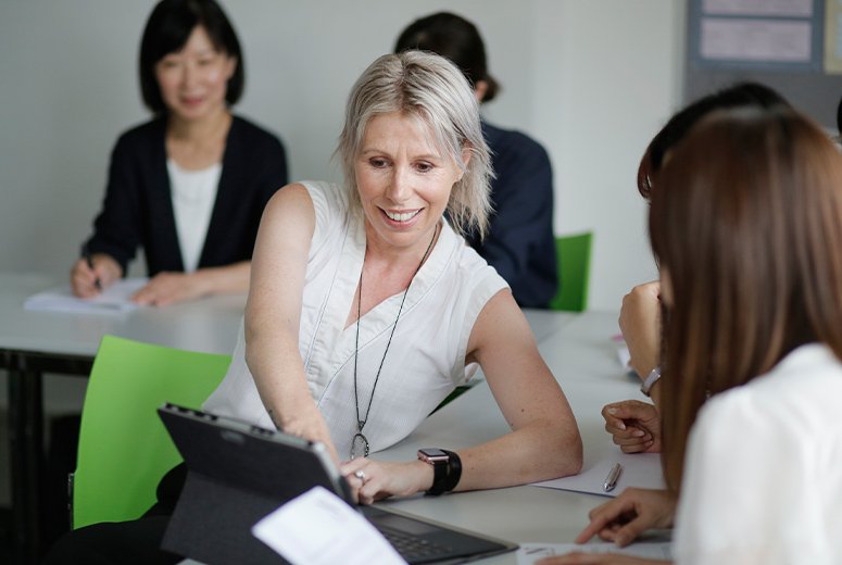 a female pointing to something on an iPad