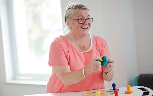 An adult holding some children's building blocks