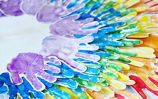 a rainbow made out of hand prints