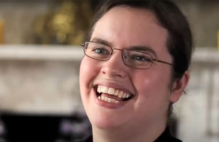 a female graduate who is now a maternity nurse smiling