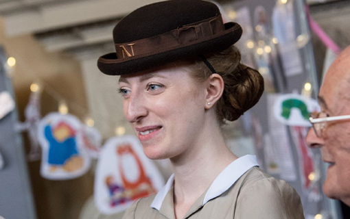 a female student in her formal uniform smiling