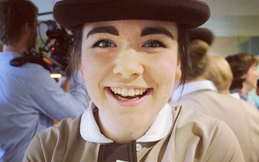 a female student in uniform smiling