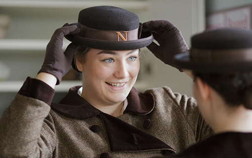 a female student adjusting her hat