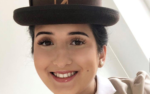 a female student in a hat smiling
