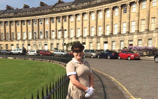 a female student stood on the royal crescent in her uniform