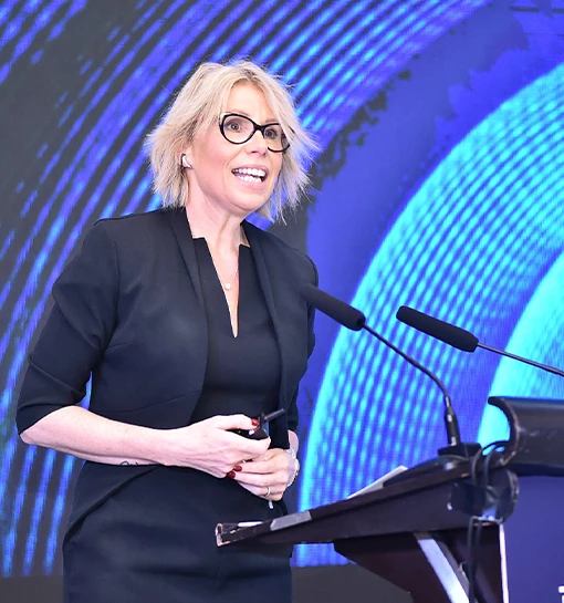 a lady on a stage speaking into a microphone