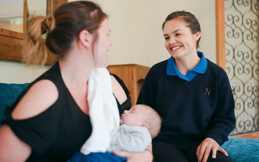 a student on placement with a parent holding her baby