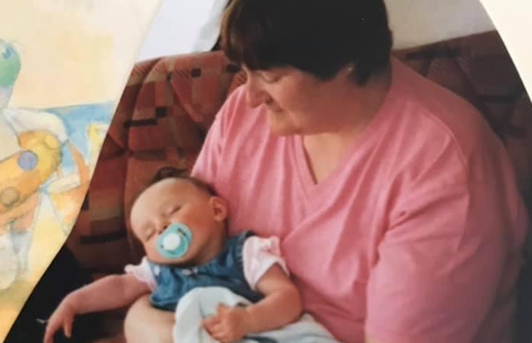 a woman holding a baby