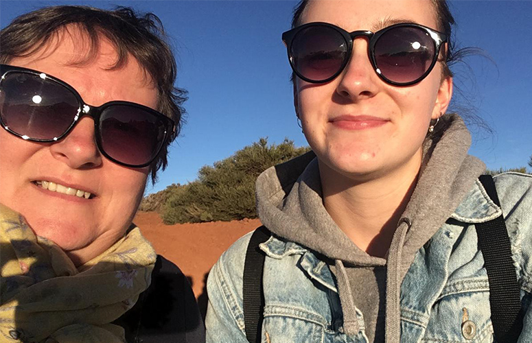 a mother and daughter smiling