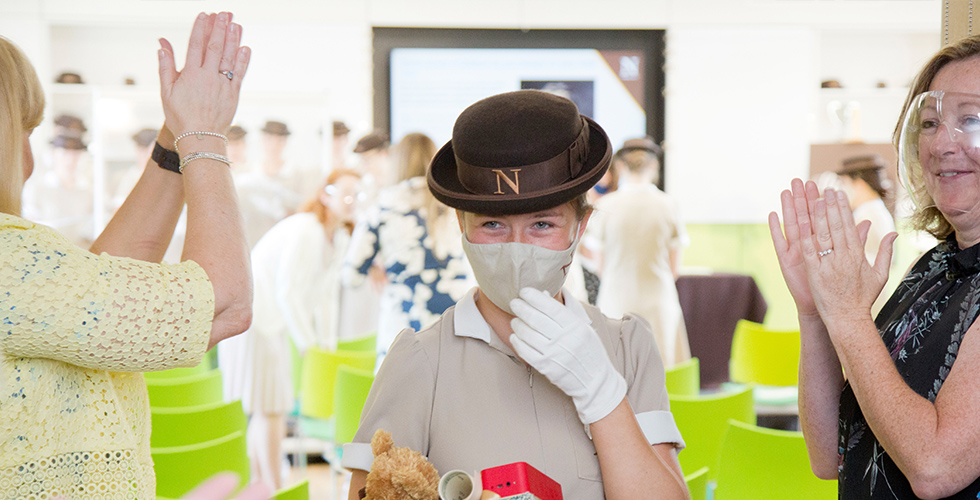 a student being clapped by lecturers
