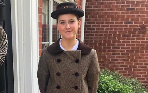 a female Norland student who completed the maternity ward placement in their formal uniform