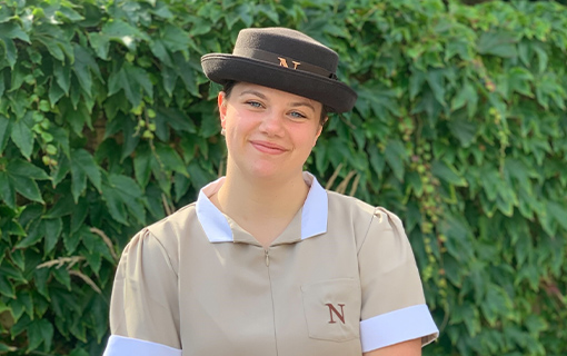 a female international student in her formal uniform