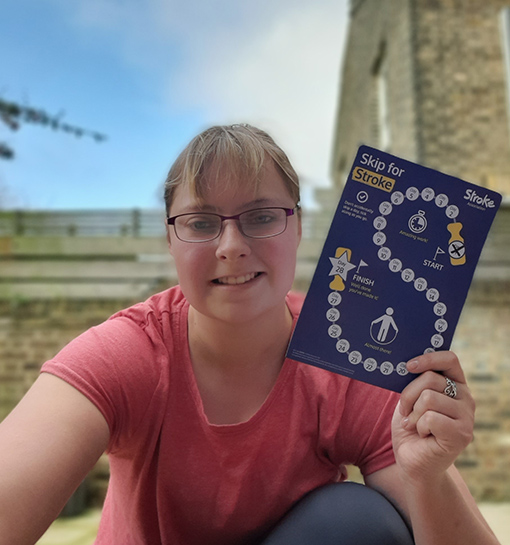 a female Norland student holding a leaflet