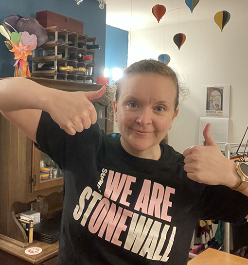 an image of a Norland Nanny wearing a t-shirt for the charity Stonewall