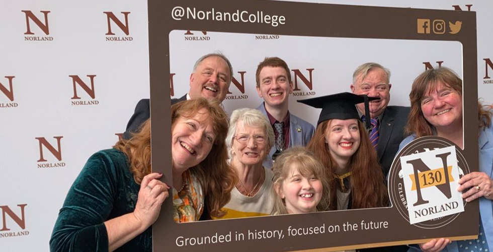 A graduate and her family posing for a photo