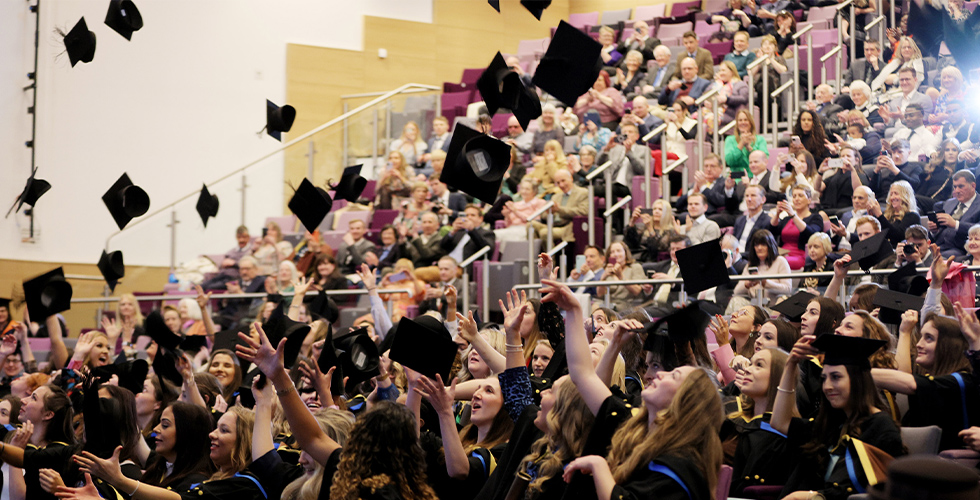 graduates throwing their hats in the air