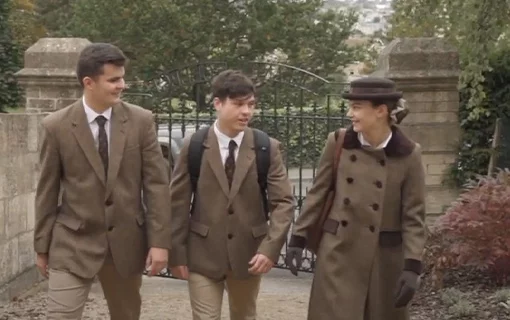 three Norland students walking up a path