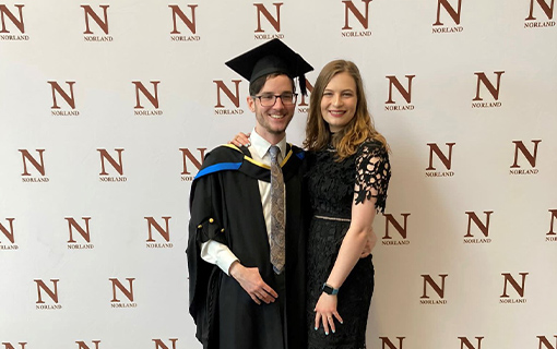 a graduate and a female smiling