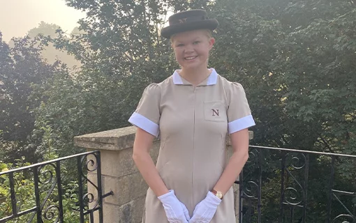 a female student smiling in her formal uniform