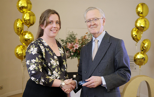 a lady being presented with an award