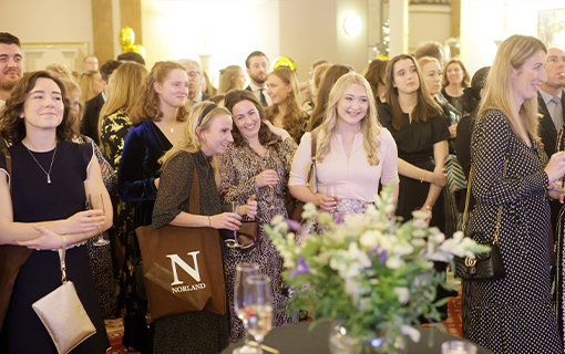 a group of people looking towards a stage