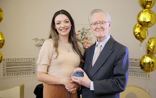 a lady being presented with an award