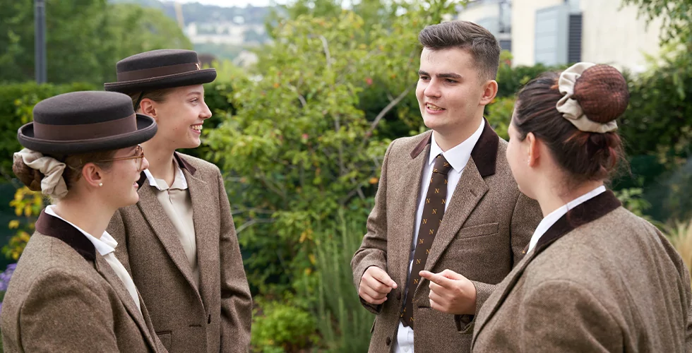 Norland Nanny students in their uniform in the garden at their Oldfield Park campus in Bath, UK.