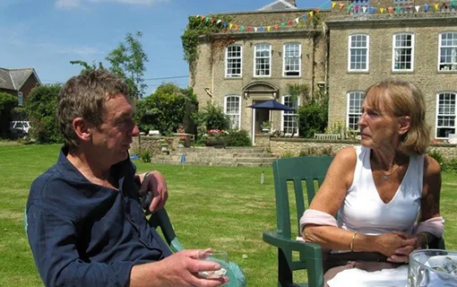 a lady and her husband sat in a garden