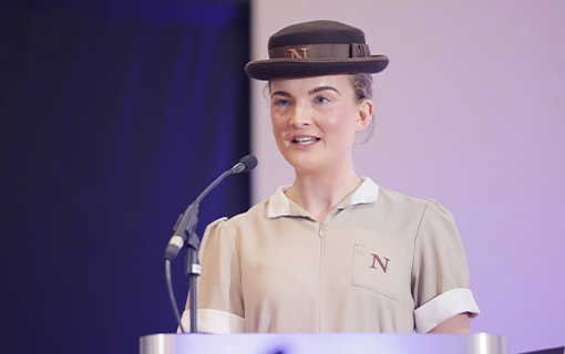 A Norland Nanny at Graduation speaking on stage