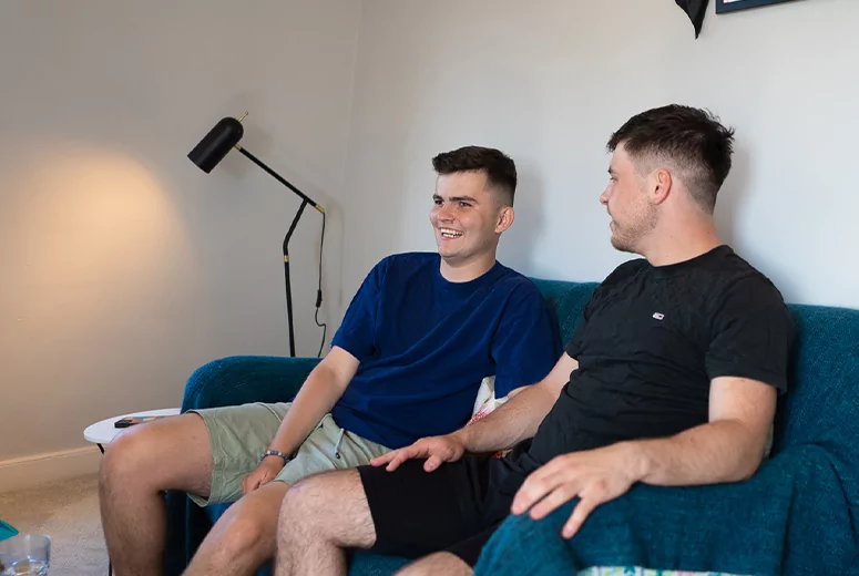 Two males sitting on a sofa