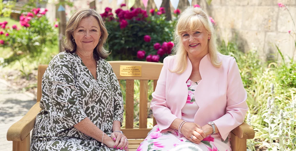 Dr Janet Rose and Mandy Edmond, Principal and Vice Principal of Norland, sat on a bench