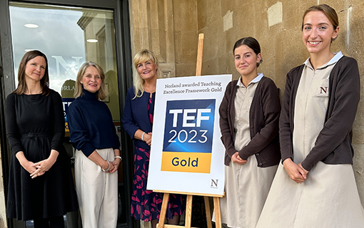 MP Wera Hobhouse with Norland Principal Dr Janet Rose, Head of Learning, Teaching and Research Dr Becci Digby and two Norland Nanny students stook in front of a TEF Gold sign