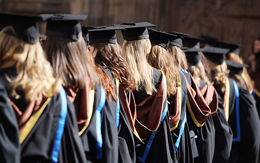 Norland graduates in their gowns lining up outside Bath Abbey