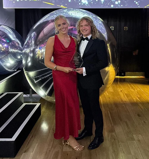 Sam and Lillie, Head and Deputy Head of Students at Norland holding the Whatuni Student Choice Award for best Small or Specialist provider