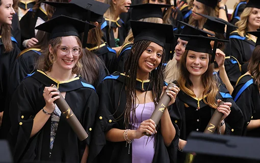 Early years graduates at Norland at their graduation ceremony smiling