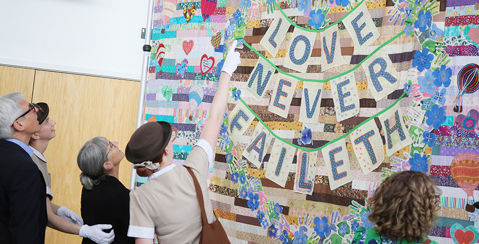 Norland student pointing to quilt pattern showing family