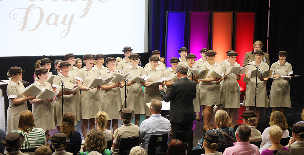 Norland choir on stage performing in formal uniform