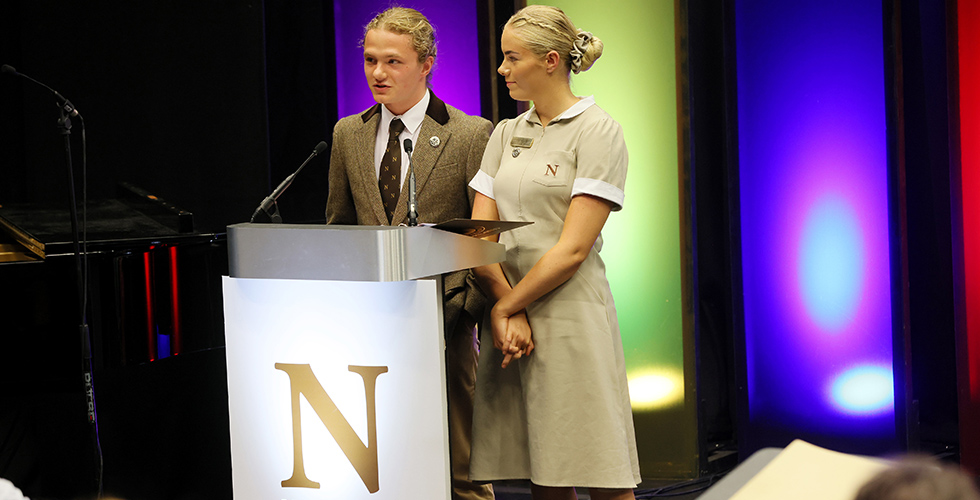 Head of students making speech on stage