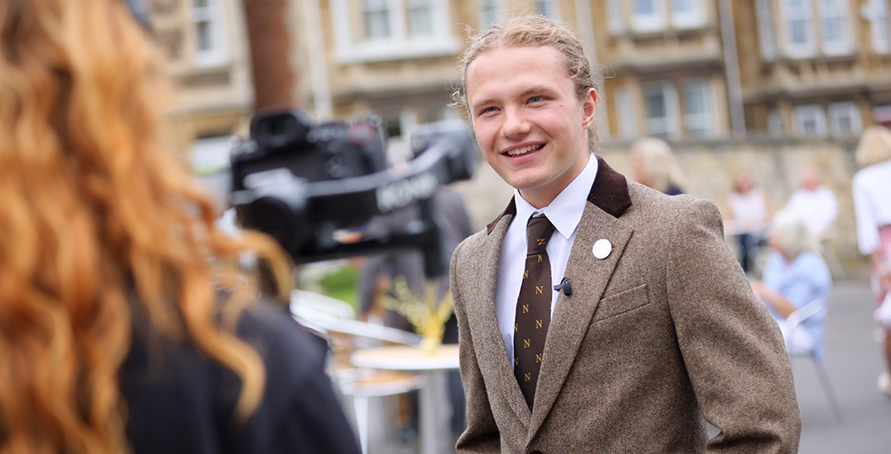 Norland student being interviewed behind professional camera