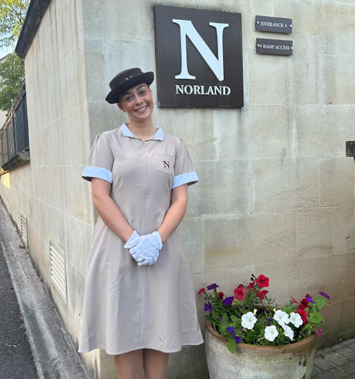 Norland student in formal uniform outside of building