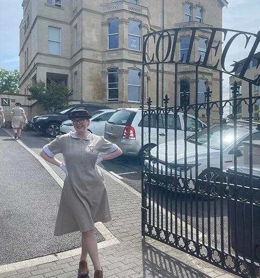 Student in uniform outside of Norland gates on campus