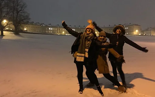 Group of Norland students posing in front of snowy Bath Royal Crescent