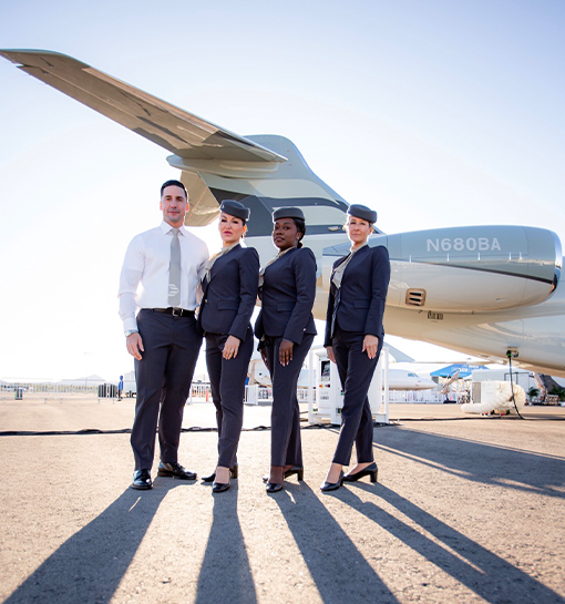 Cabin crew from Bombarider stood by an aeroplane